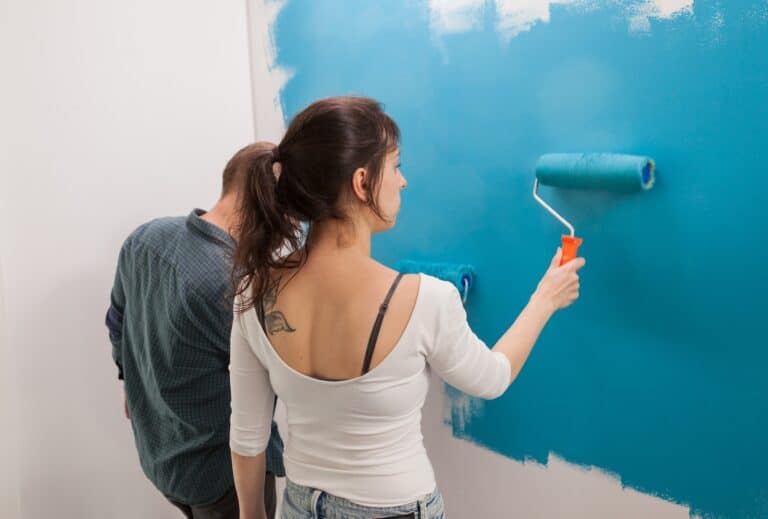 Woman painting wall